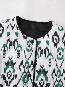 Detailed close-up of quilted jacket with tie-dye patterns and black button closure