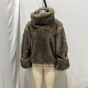 Detail of high neck faux fox fur jacket in brownish grey with thick plush long sleeves