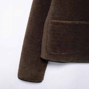 Deep brown fleece jacket with black faux leather trim detailing on cuffs and pockets