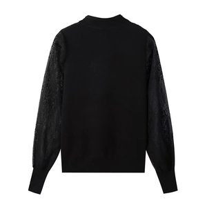 Women's vintage black knit sweater with lace patchwork and ribbed trim shown from the back