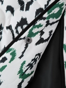 Detail of leopard print quilted jacket showing texture and vintage metal button closure