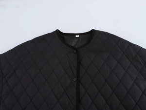 Detail of black diamond quilted jacket with snap buttons and a high-quality ribbed collar
