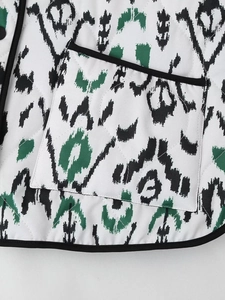 Detail of diamond quilted jacket with ikat pattern and high-quality black hem finishing