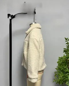 Close-up of cream white teddy fleece jacket featuring thick texture and relaxed fit style
