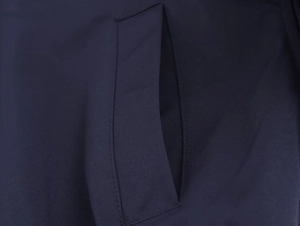 Close-up of navy blue baseball jacket welt pocket with premium stitching detail