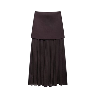 Detailed view of dark brown knit and pleated chiffon patchwork on midi skirt