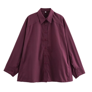 Detailed close-up of dark purple blouse collar with white size S neck label