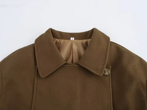 Detailed close-up of brown wool coat collar with satin lining and S size label