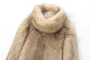 Detail of high neck faux fur jacket showing soft beige texture and plush craftsmanship