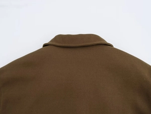 Detail of the stand collar and stitching on a dark brown wool blend winter coat for women