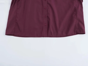 Detailed view of dark red shirt buttons and smooth cotton blend fabric texture