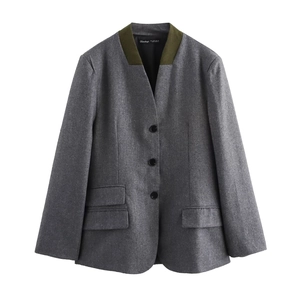 Detailed view of dark grey wool blazer featuring contrasting olive green stand-up collar design