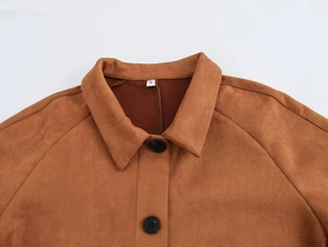 Detail view of brown suede jacket showing classic lapel, black buttons and fine stitching