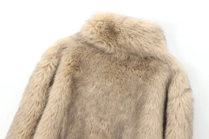 Detail view of thick khaki faux fur collar and plush texture on a stylish coat