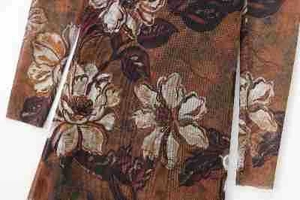 Close-up of vintage floral jacquard fabric with brown and white blossom texture