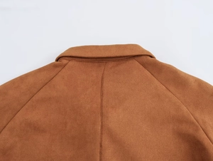 Detail of the brown faux suede collar and precise stitching on this women's coat