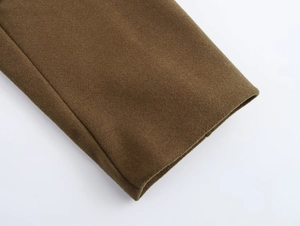 Close-up of thick olive green wool fabric texture with clean stitching and premium finish