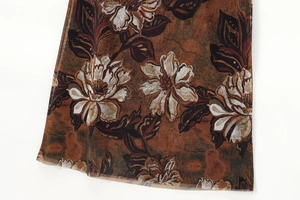 Close-up of vintage floral print on lightweight mesh fabric with retro brown tones