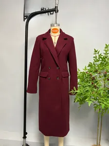 Detail view of burgundy double-breasted wool coat with classic lapels and flap pockets