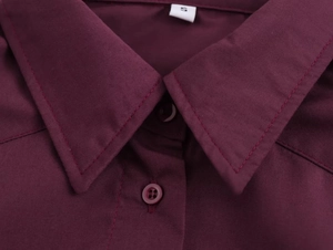 Detail of burgundy shirt collar with button fastening and size S woven label