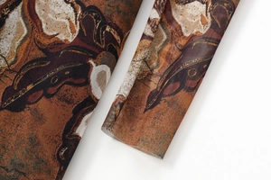 Detail of sheer mesh sleeve with abstract brown butterfly print and fine stitching