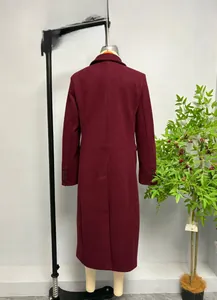 Detailed close-up of wine red wool blend coat sleeves featuring four black decorative buttons