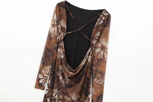 Detail of backless floral mesh dress featuring thin cross straps and earthy brown tones