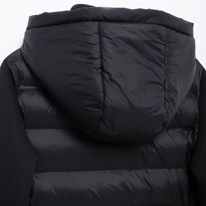 Women's black quilted hooded puffer jacket with hybrid softshell sleeves for street fashion