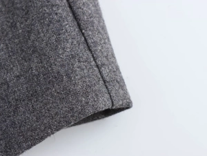 Macro detail of dark heather grey wool fabric texture and high-quality vertical stitching