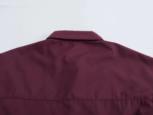 Detailed back view of the burgundy raglan shirt collar with precise stitching craft