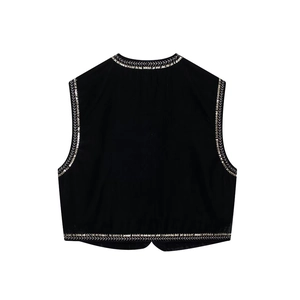 Dettaglio del retro di un gilet in velluto nero con raffinati ricami di paillettes argento