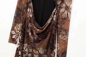 Detailed macro shot of vintage floral mesh fabric and elegant draped neckline design