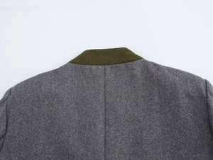 Detailed view of gray wool blazer collar with contrasting olive green suede lining