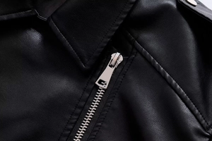 Close-up of black PU leather jacket lapel featuring polished silver metal zipper detail