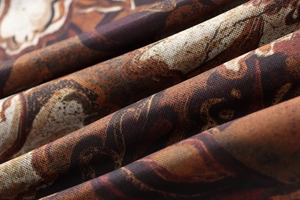 Close-up detail of vintage baroque print mesh fabric with intricate brown textures