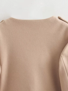 Close-up detail of the camel wool coat neckline with high-quality fabric texture