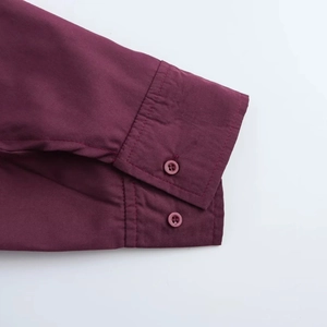 Deep red cotton shirt featuring raglan sleeves and neat double-button cuffs detail