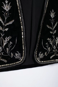 Macro di un gilet di velluto con intricati ricami floreali in fili d'oro e d'argento