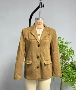 Detailed shot of camel faux suede blazer featuring a single-breasted design and flap pockets