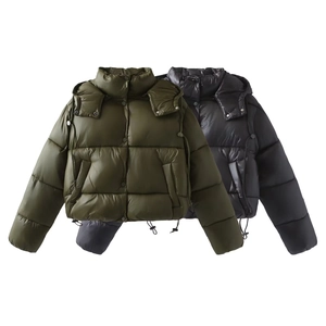 Detail view of cropped puffer jackets in army green and black with adjustable hem drawstring