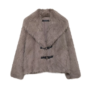 Detail of grey faux fur coat featuring wide lapels and black leather buckle straps with D-rings