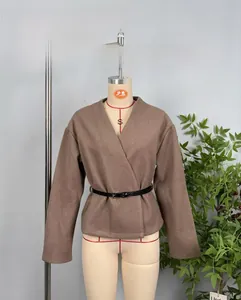 Detail of a brown autumn coat with a black leather belt on a mannequin for styling