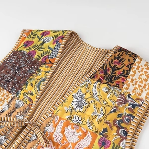 Detail of floral patchwork quilted vest with lace-up closure and striped lining