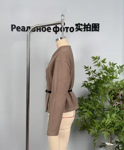 Detail of dark brown wool coat featuring a slim-fit silhouette and a thin black leather belt