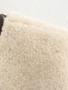 Detailed close-up of soft cream faux fur texture with high-quality plush material finish
