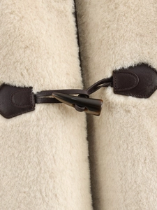 Close-up of faux fur texture with classic toggle closure and leather details