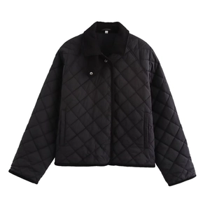 Detail of black quilted jacket with corduroy collar and snap button closure for women