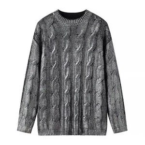 Detail of cable knit pattern and ribbed cuffs on this grey round neck sweater