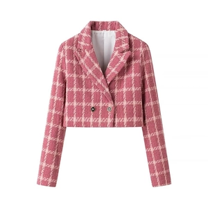 Macro detail of pink plaid tweed cropped blazer showing woven texture and black buttons
