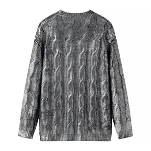 Detailed back view of silver metallic cable knit sweater with textured patterns